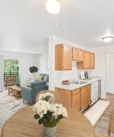 a kitchen and dining room with a table and chairs at Whisperwood, Washington 98168