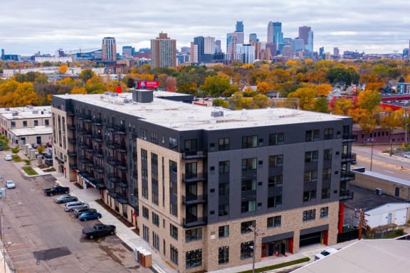 an aerial view of a building with the skyline in the background