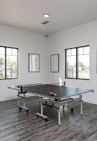 A room with a pool table and pictures on the wall.
