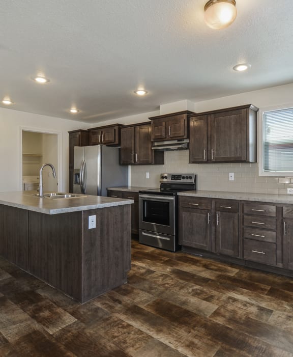 a kitchen with wooden cabinets and stainless steel appliances