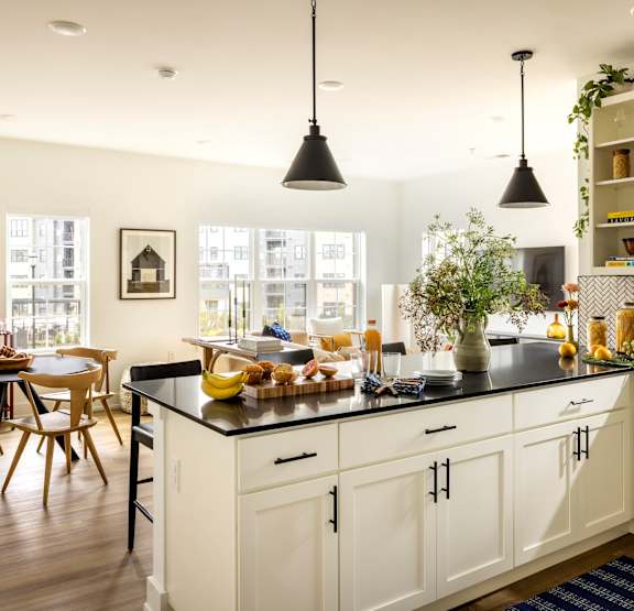 a kitchen and living room with a checkered floor