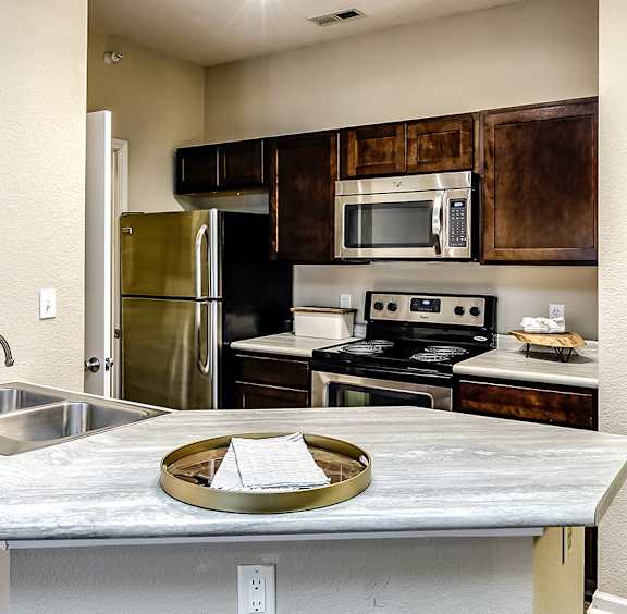 A modern kitchen with a dining table and chairs.