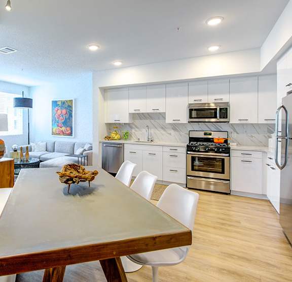 A modern living room with a yellow sofa and a fireplace. at Baker Block, Costa Mesa, CA, 92626