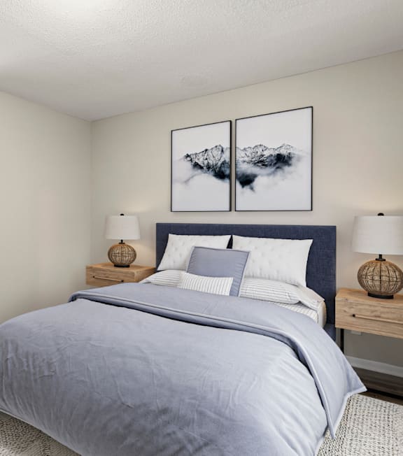 A bedroom with a large bed and two lamps on either side at Woodbriar Management in Tucker, Georgia