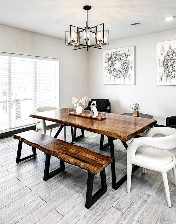 a dining room with a wooden table and chairs
