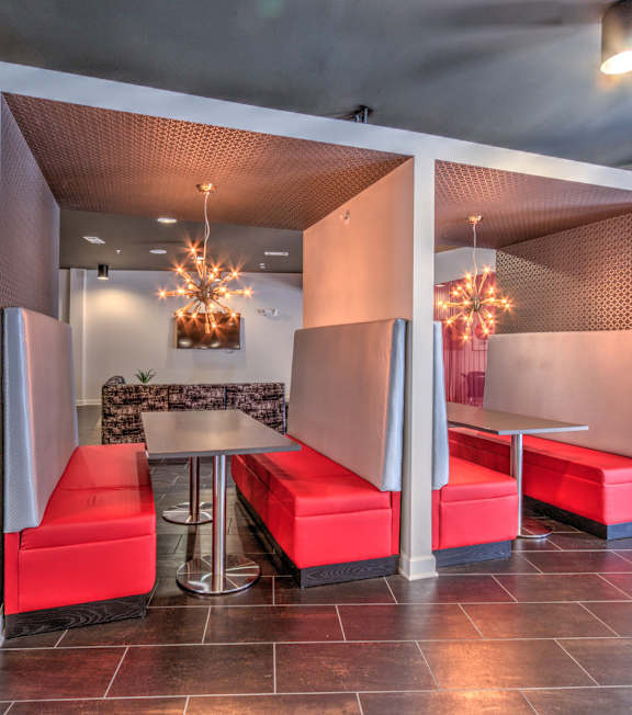 A room with a table and chairs with a red cushion. A room with a table and chairs with a red cushion at Highland Row Apartments, Tennessee, 38111
