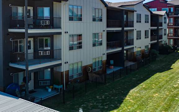 an exterior view of a building with fenced yards  at Brooklyn West, Missoula, MT, 59808