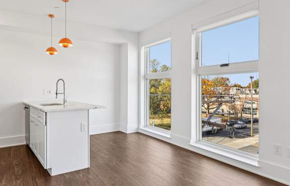 A kitchen with a white cabinet and a sink is shown.