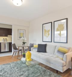 a living room with a couch and a table and a kitchen