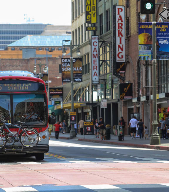 a bus driving down a city street with bikes on the front