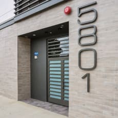 a view of the entrance to the building with the number 5690 on the side of the at The Fairfax Flats Apartments, Los Angeles, CA, 90019