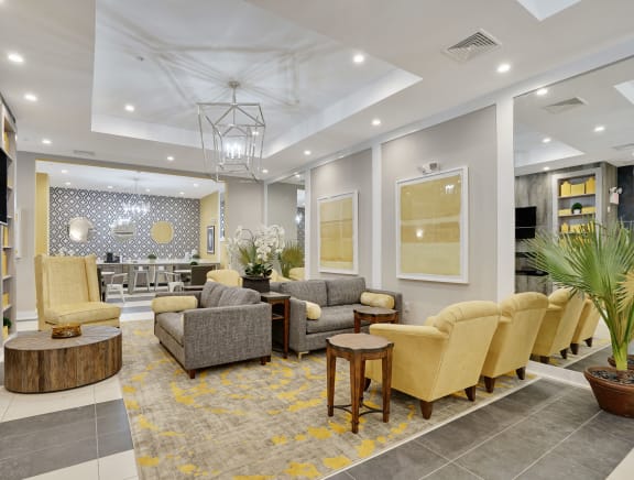 a lobby with couches and chairs and a tv