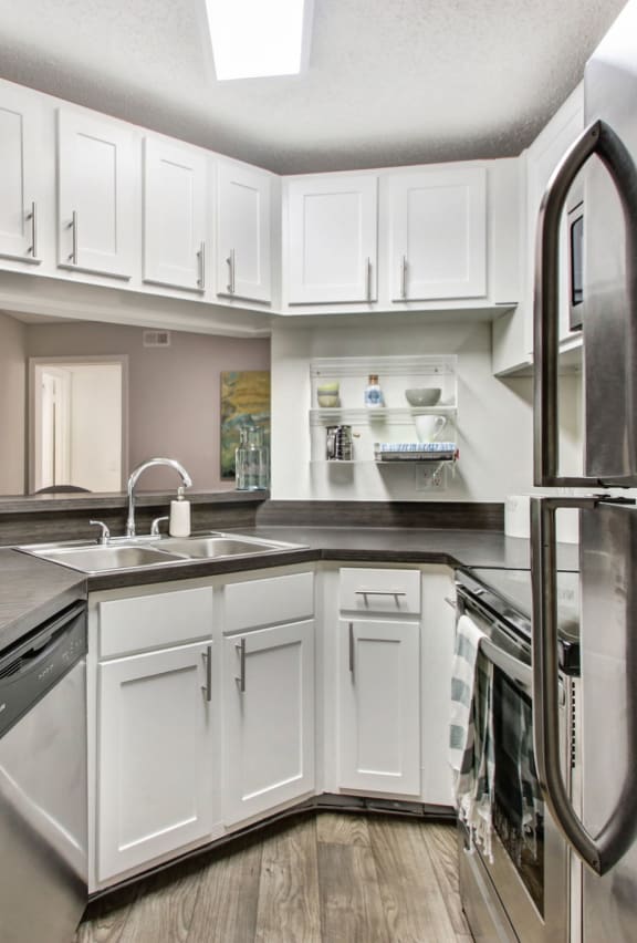 a kitchen with white cabinets and stainless steel appliances at Timberwalk at Mandarin, Jacksonville, FL, 32257