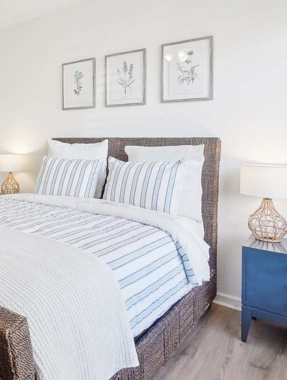 A bedroom with a large bed and a ceiling fan.
