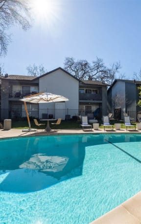 our apartments have a large pool with chairs and umbrellas at Danville Park, California