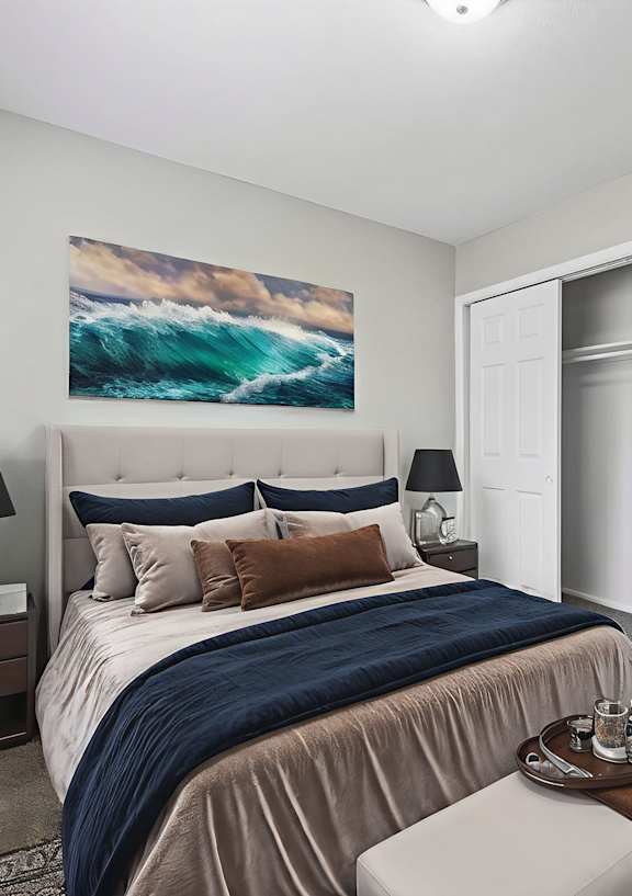 A living room with a white couch, a brown coffee table, and two pictures on the wall.