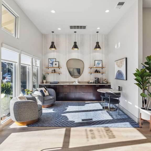 A modern living room with a grey sofa and a wooden coffee table.