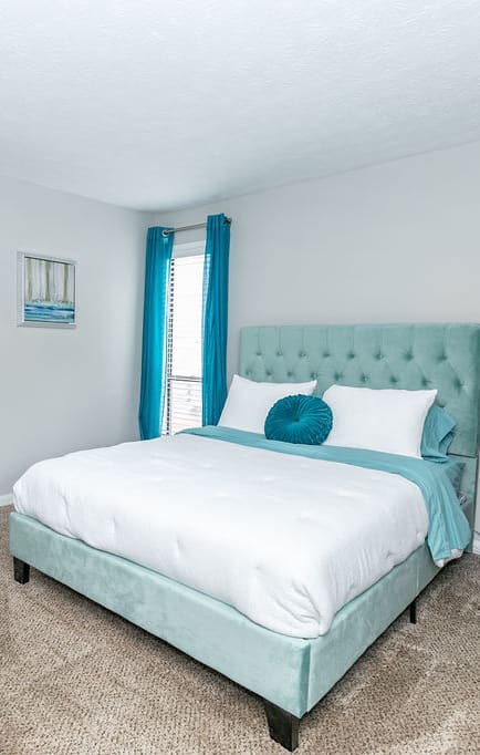 a bedroom with a bed and a closet  at The Atlantic Howell Station, Duluth, GA