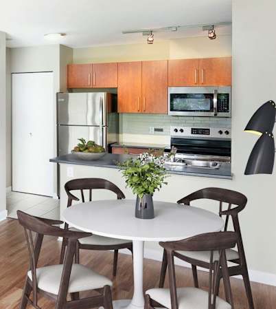 Spacious one-bedroom suite, staged in the mid-century modern style.