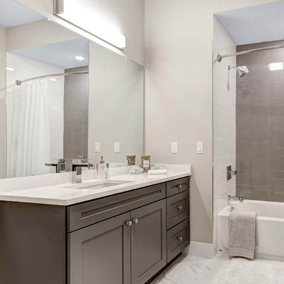 A bathroom with a white shower curtain and a white sink.