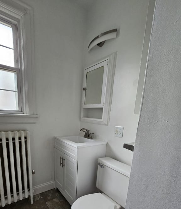 a small bathroom with a toilet and a window at Cincinnati Premier Living*, Cincinnati