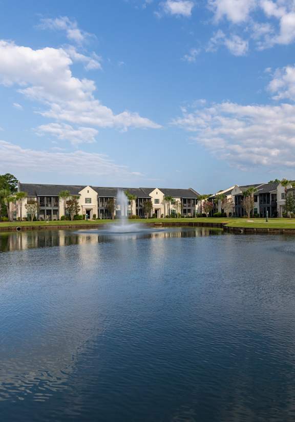 the front of a house with a courtyard and a fountain at Residences at 393 North Apartments, Santa Rosa Beach, Florida
