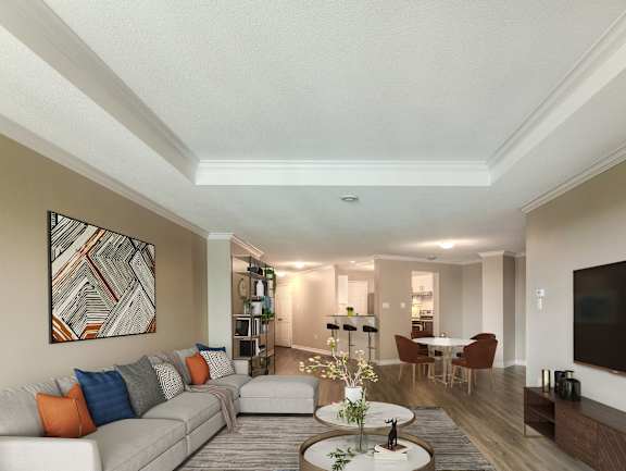 A living room with a white couch and a grey coffee table.