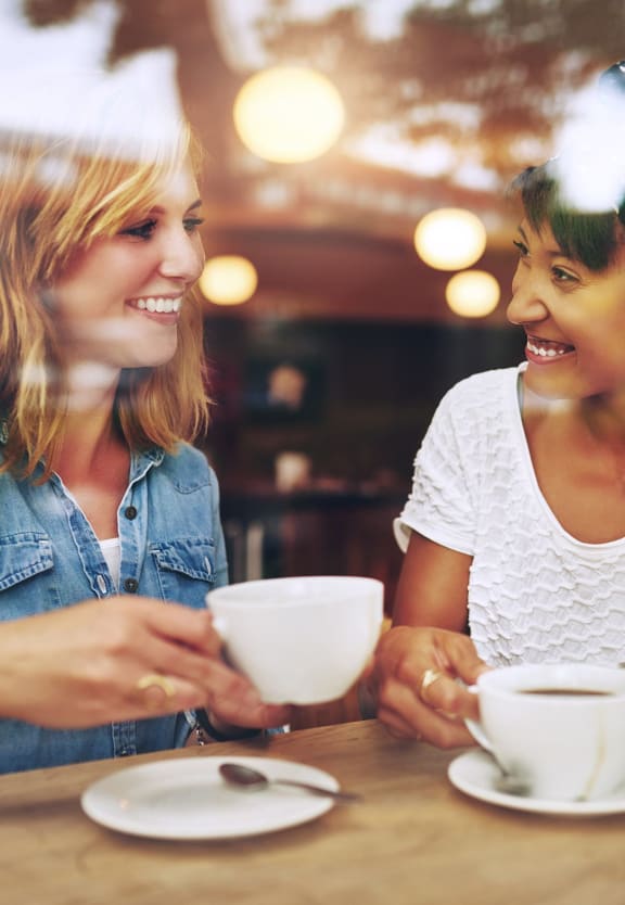 This is a photo of two female friends having coffe at the local coffee shop.