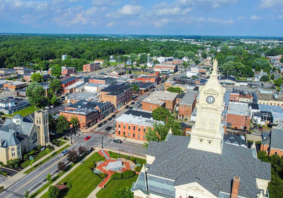 A cityscape with a prominent clock tower in the center.