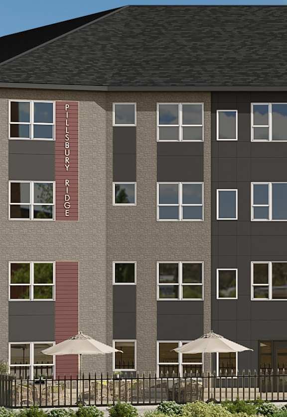 A large building with a black roof and a lot of windows.