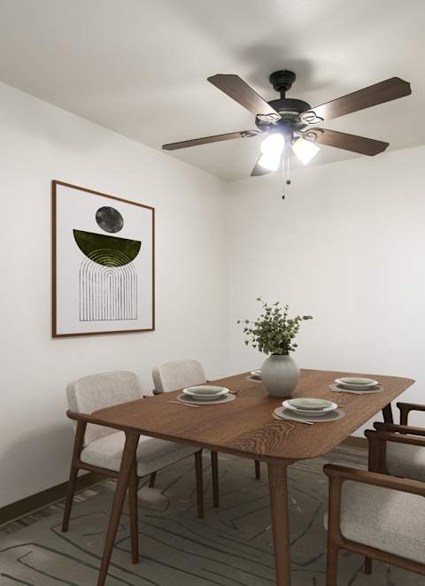 A dining room with a table set for four.