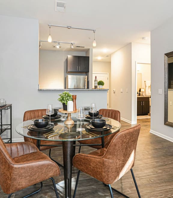 a dining room with a table and chairs and a kitchen