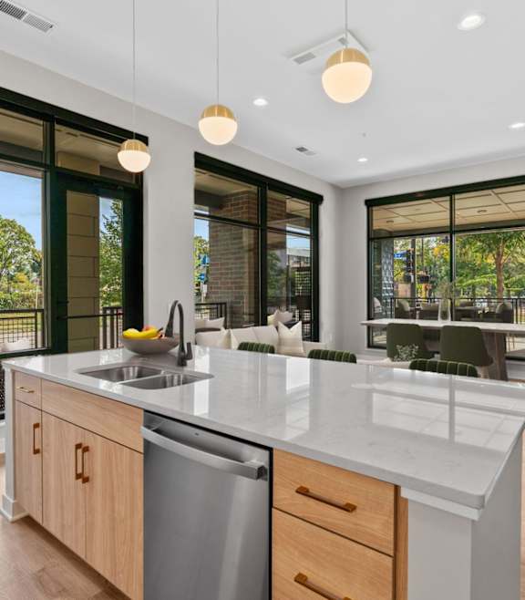 a large kitchen with a large island with white chairs at Expo, Minneapolis Minnesota