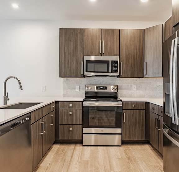 A modern kitchen with stainless steel appliances at Upper Vue Flats, Dublin, Ohio