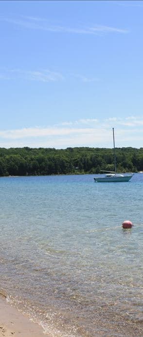 a boat in the water near a beach