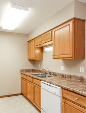 a kitchen with white appliances and granite counter tops