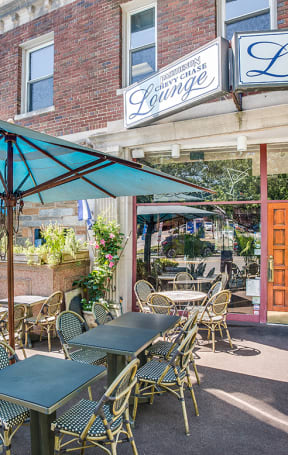 An outdoor patio with tables and chairs and umbrellasat Legation House in Washington, DC 20015