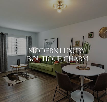 a living room with a table and a couch at Capital Flats & Magnolia Square Apartments, North Carolina, 27601