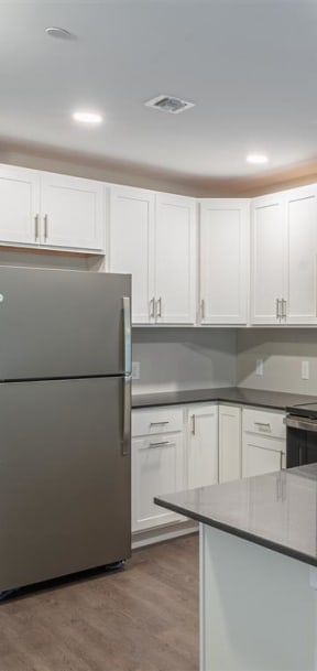 a kitchen with white cabinets and a black stove and refrigerator