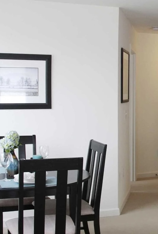 a dining room and a kitchen with a table and chairs