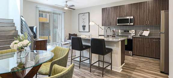 A modern kitchen with a dining table and chairs.