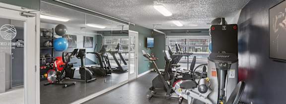 A gym with a variety of exercise equipment.