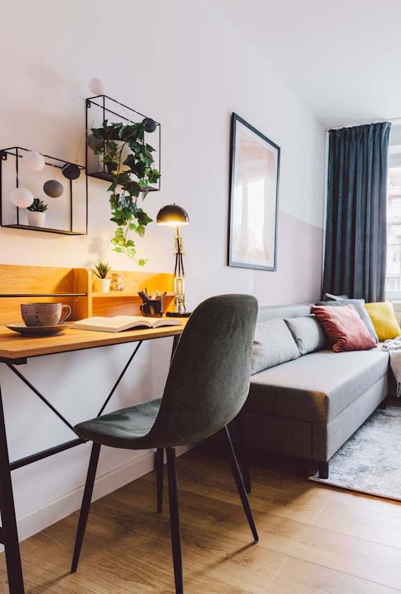 A living room with a grey chair and a wooden table.