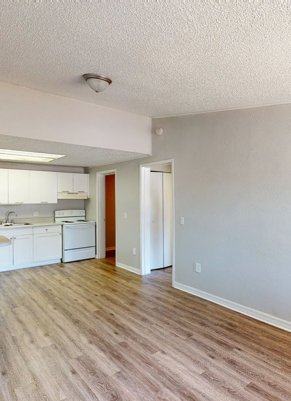 a kitchen area with hardwood floors at Mount Dora Apartments