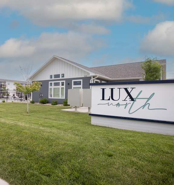 A sign that says "LUX" in front of a building.