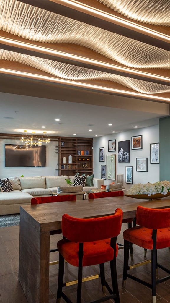 a dining room and living room with a large table and chairs