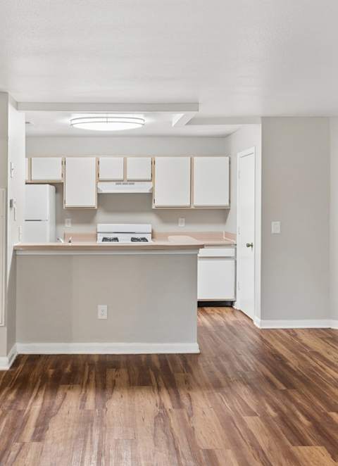 A room with wooden floors and white walls.