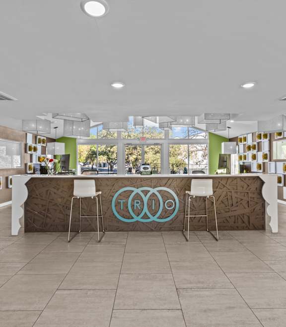 the lobby of the olympic club with a bar and chairs