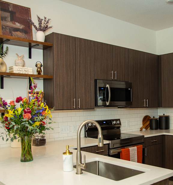 A kitchen with brown cabinets and a white countertop.