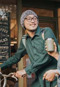 A man with a bicycle and a woman standing outside a coffee shop.at 2221 S Western, California, 90018